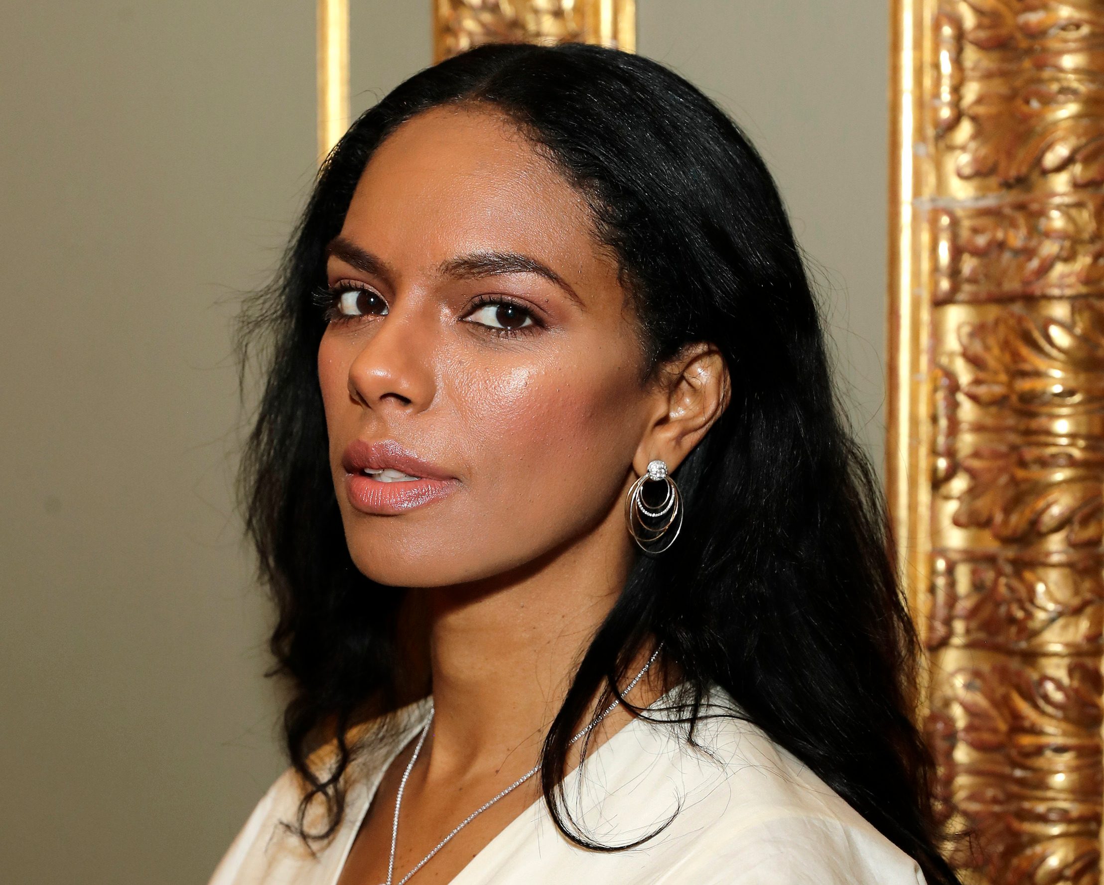Round cut diamond hoop earrings and diamond bolo necklace worn by Noëlla Coursaris Musunka.