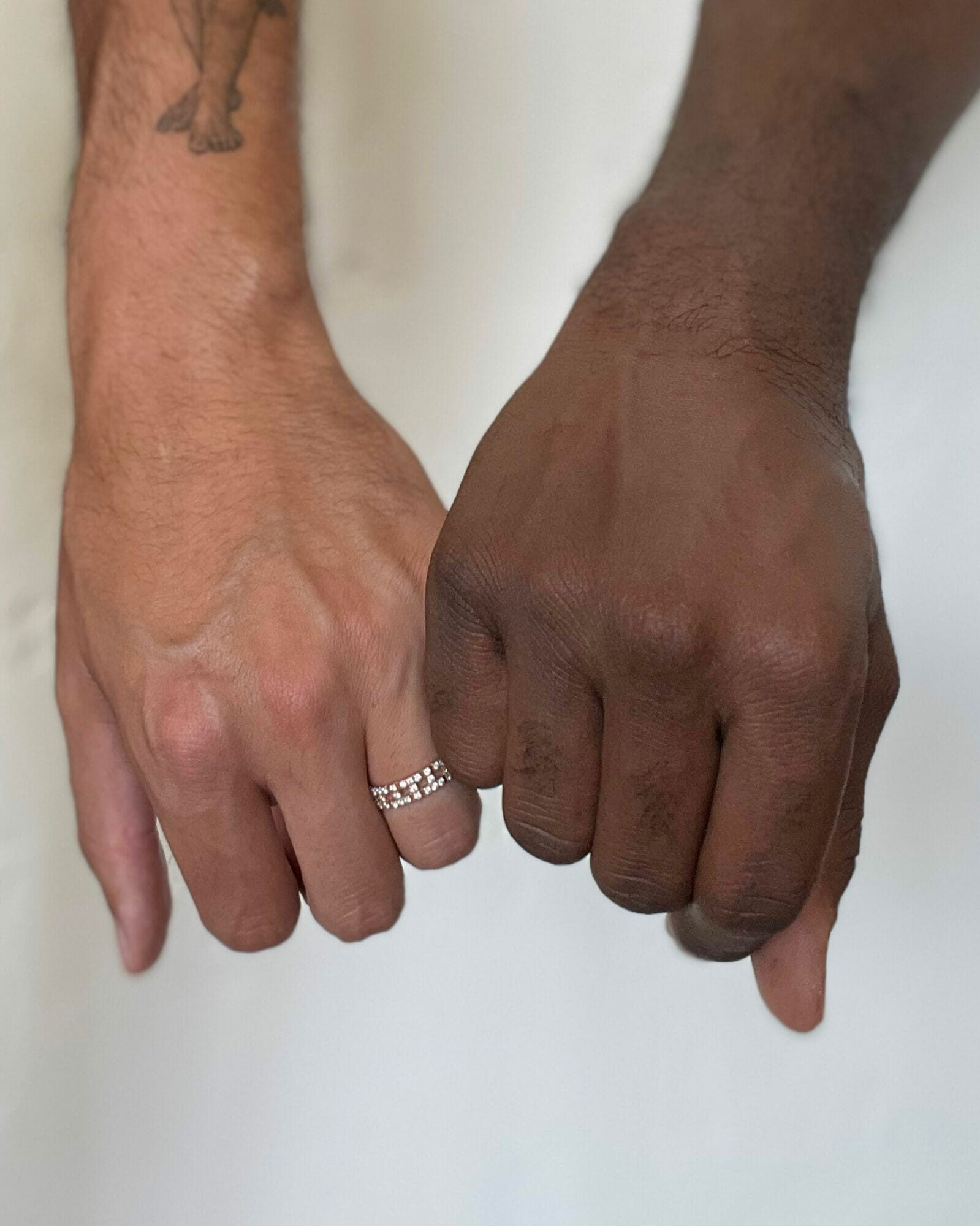 Phillip Picardi and Darien Sutton locking fingers