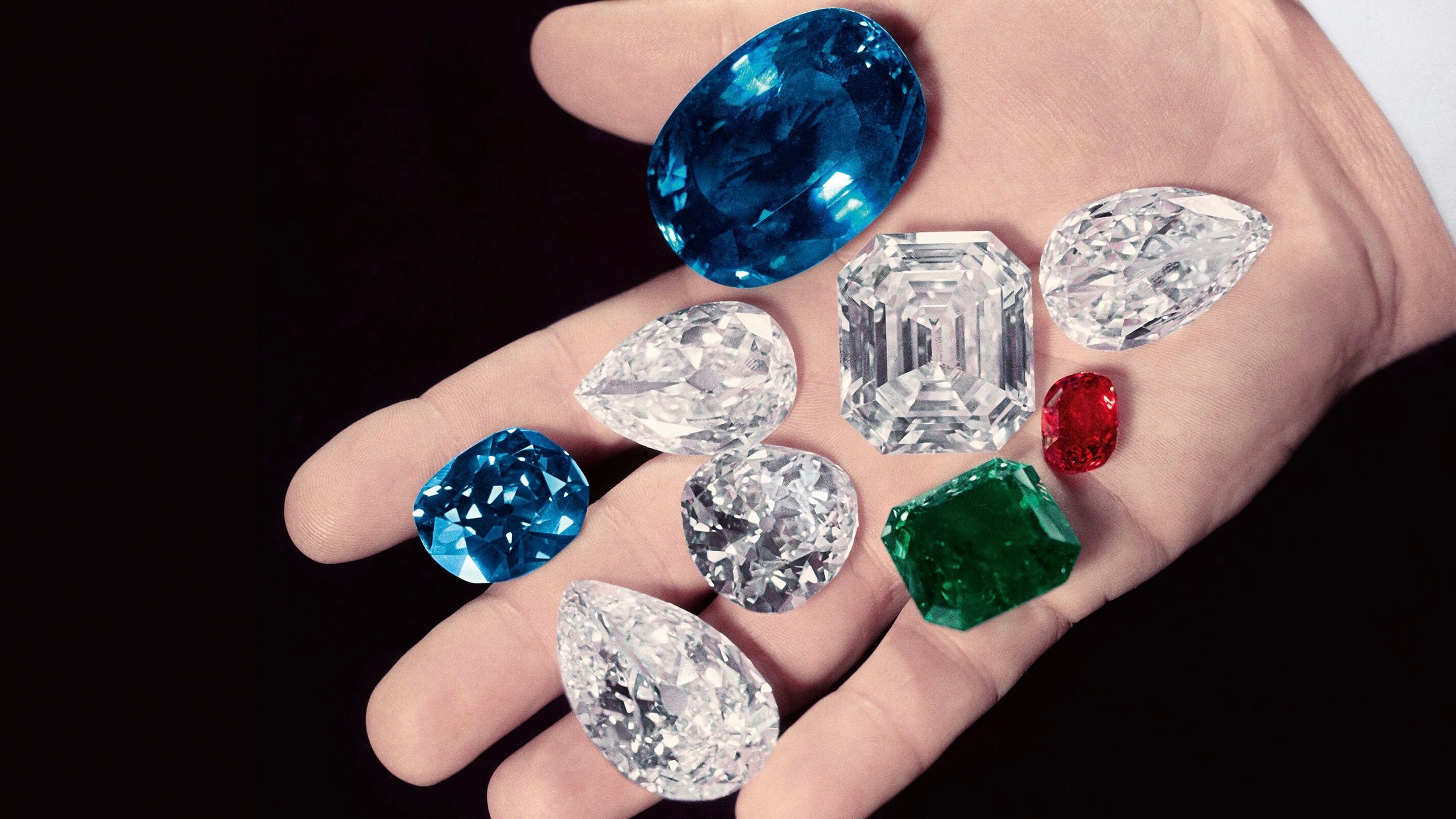 Harry Winston displays some of the gems in his collection in the palm of his hand, including the Sapphire of Catherine the Great (next to thumb), the Hope Diamond (between index & middle), the Royal Spanish Emerald (green), the Idol's Eye (left of emerald), the Jonker Diamond (C, square cut), the Star of the East diamond (tear shaped, bottom), a large ruby and a pair of 50-carat matched pear shaped diamonds. (Photo by Bernard Hoffman/The LIFE Picture Collection/Getty Images)
