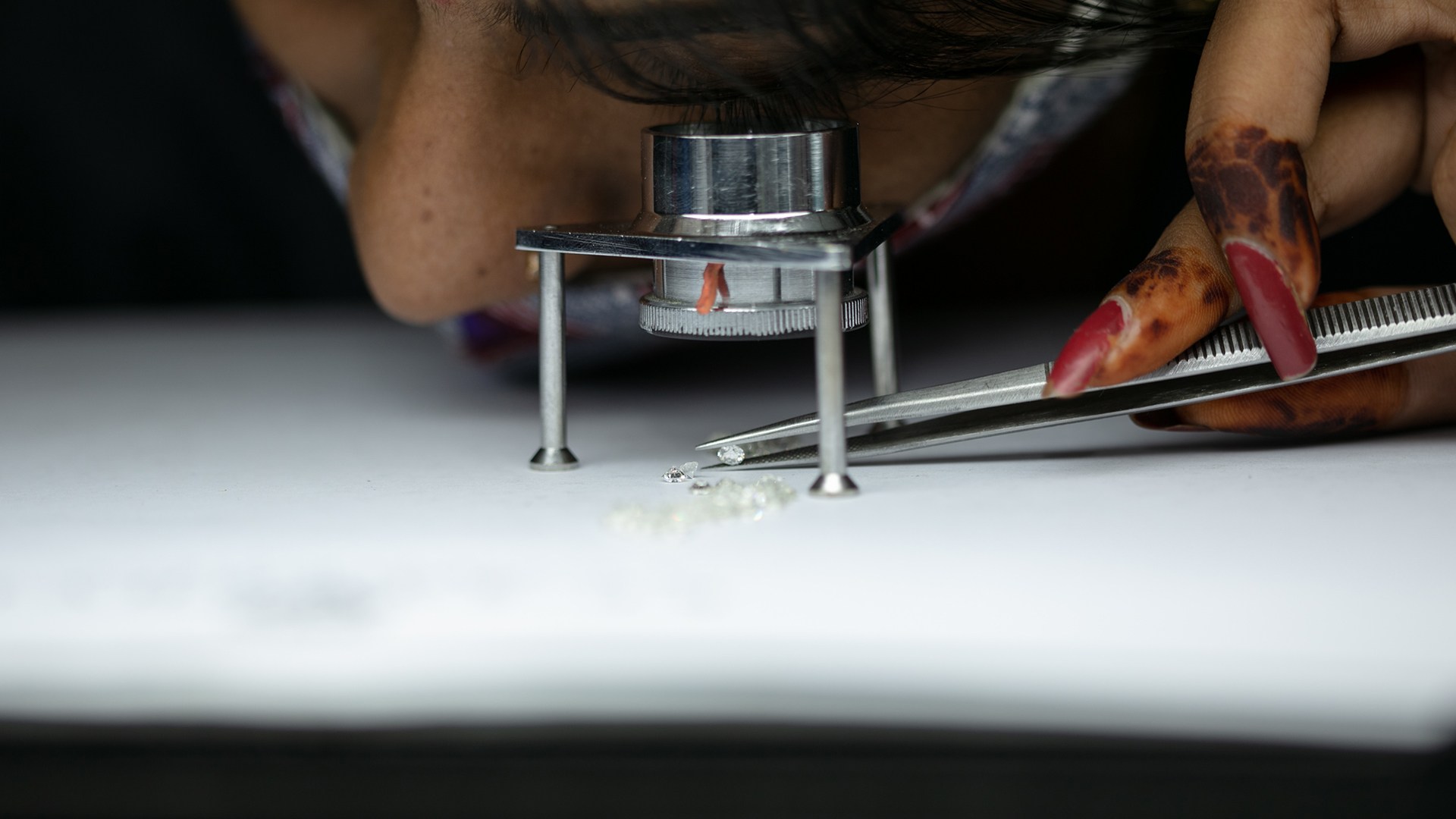Woman working in cutting and polishing facility in the diamond city of Surat