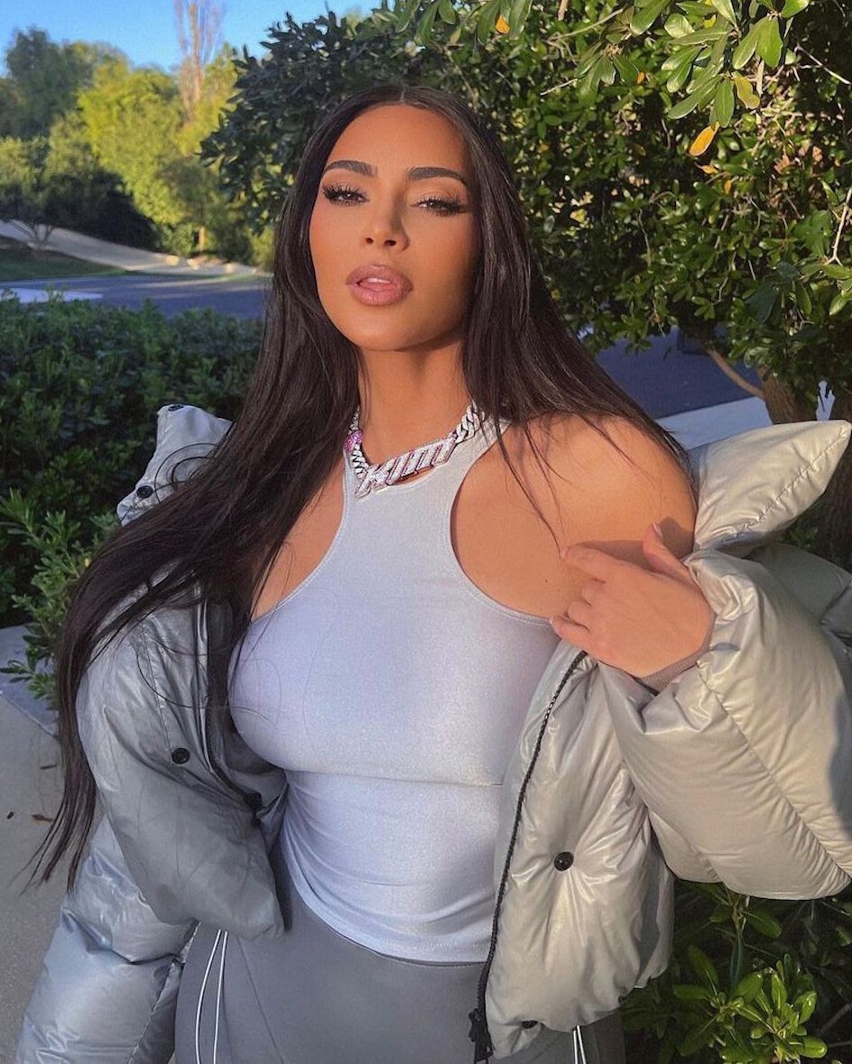 Kim Kardashian wears her name on a white diamond encrusted Cuban link chain necklace with pink diamond hearts, gifted to her by Eric Mavani.