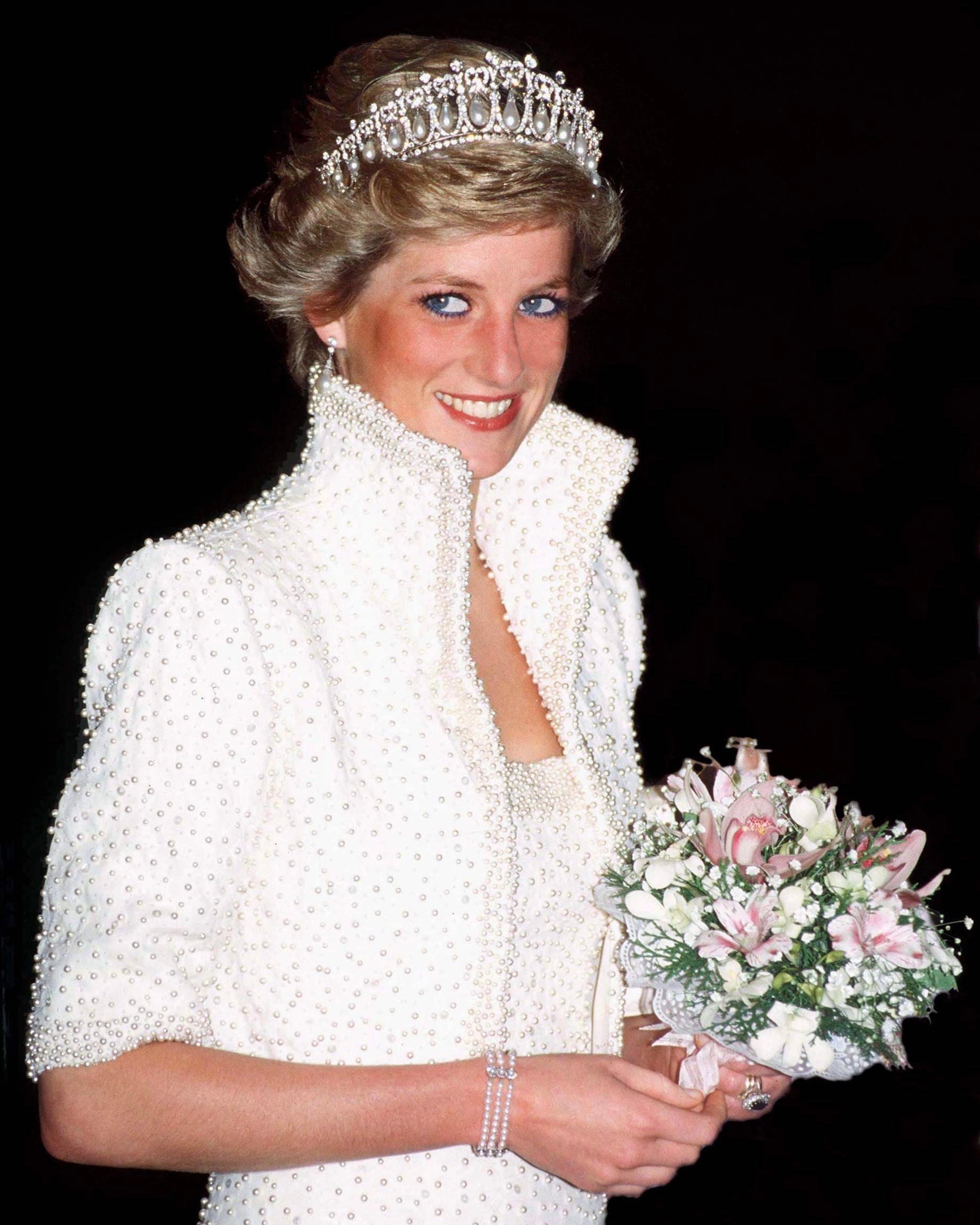 Diana, Princess of Wales, wore the "Elvis Look" Designed By Catherine Walker and the Cambridge Lover’s Knot Tiara in Hong Kong in 1989