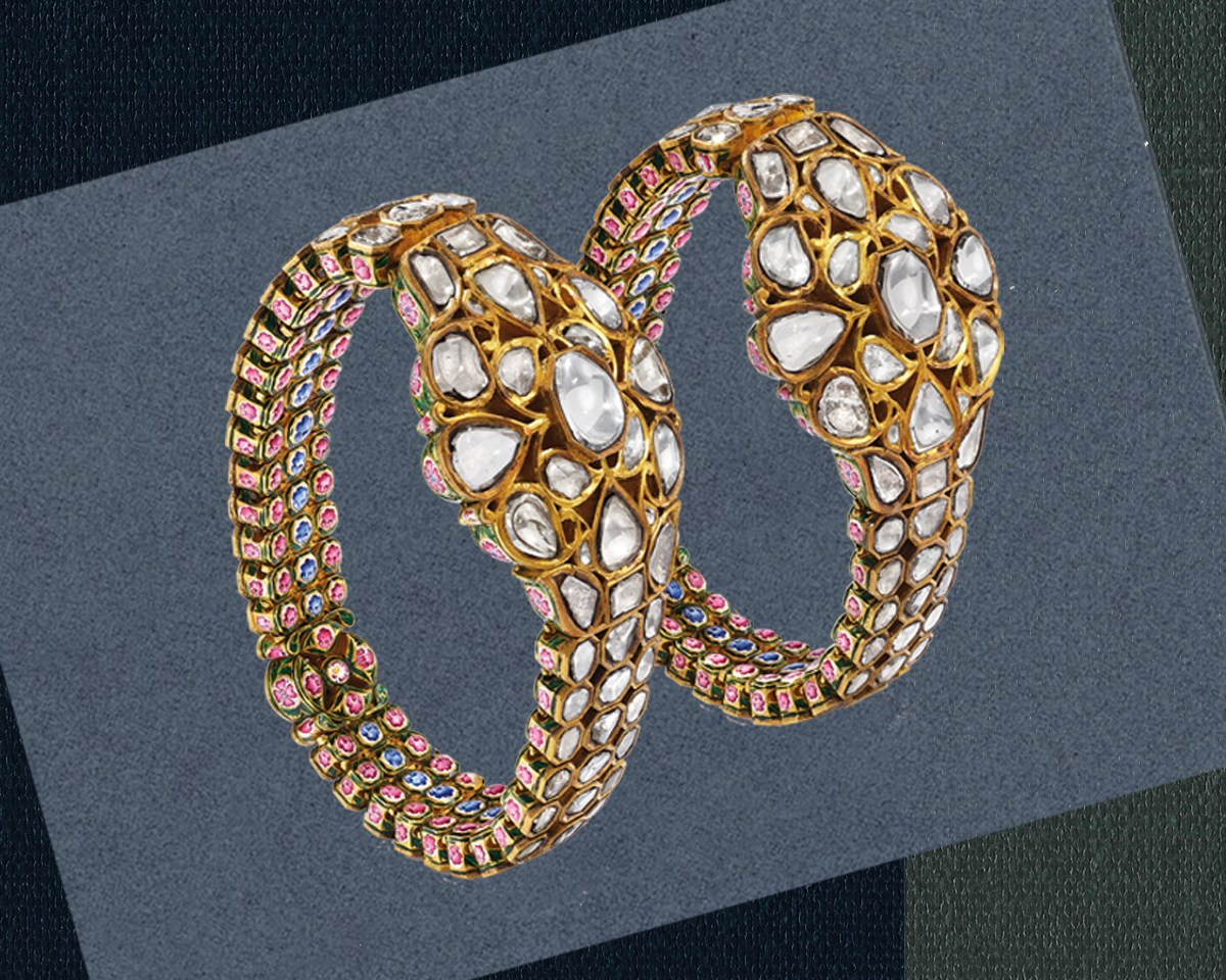 A pair of gold bracelets with gemstones