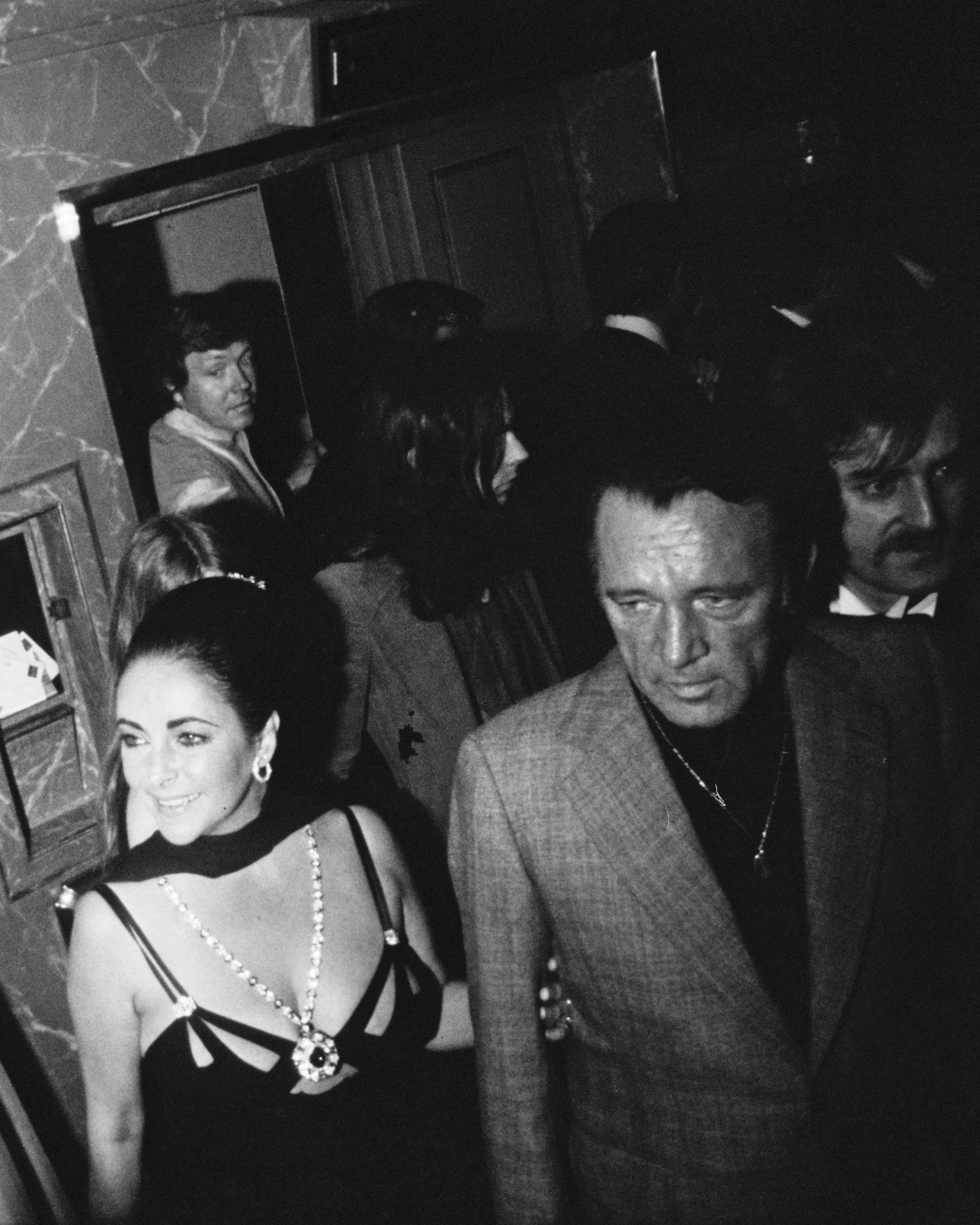 Elizabeth Taylor and Richard Burton at Burton's 50th birthday party, held at the Dorchester Hotel, London, 10th November 1975. (Getty Images)