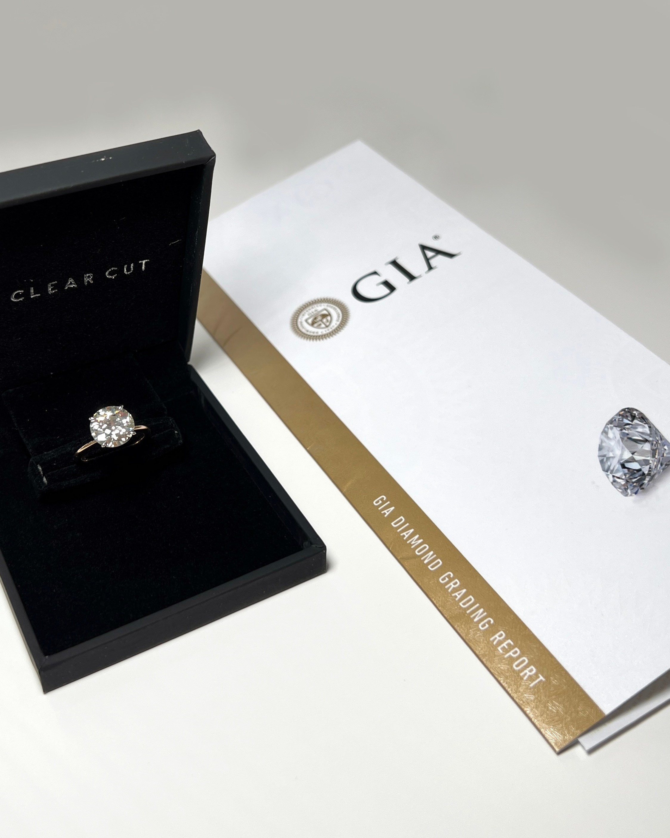 Diamond Ring Courtesy of The Clear Cut, Pictured with a GIA Diamond Grading Report (Only Natural Diamonds) Buy an Engagement Ring Online Shopping for a Diamond 