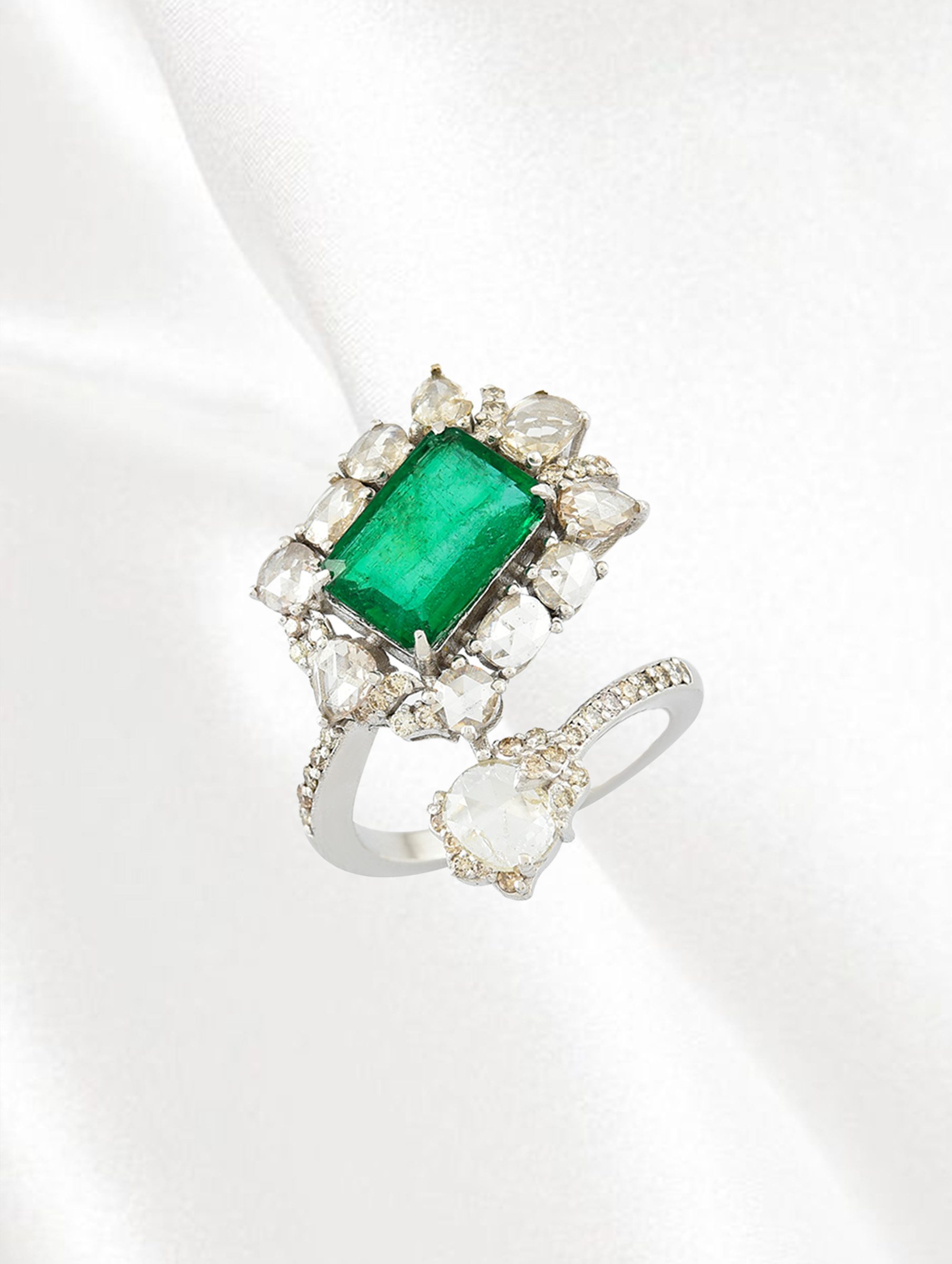 Emerald and diamond ring with a diamond-frosted band from Amrapali