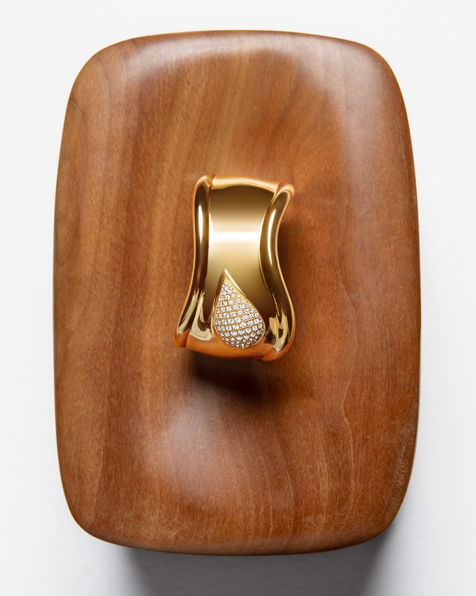 Elsa Peretti Bone cuff in 18k gold with pavé diamonds, small motif, right wrist. (Courtesy of Tiffany & Co.)