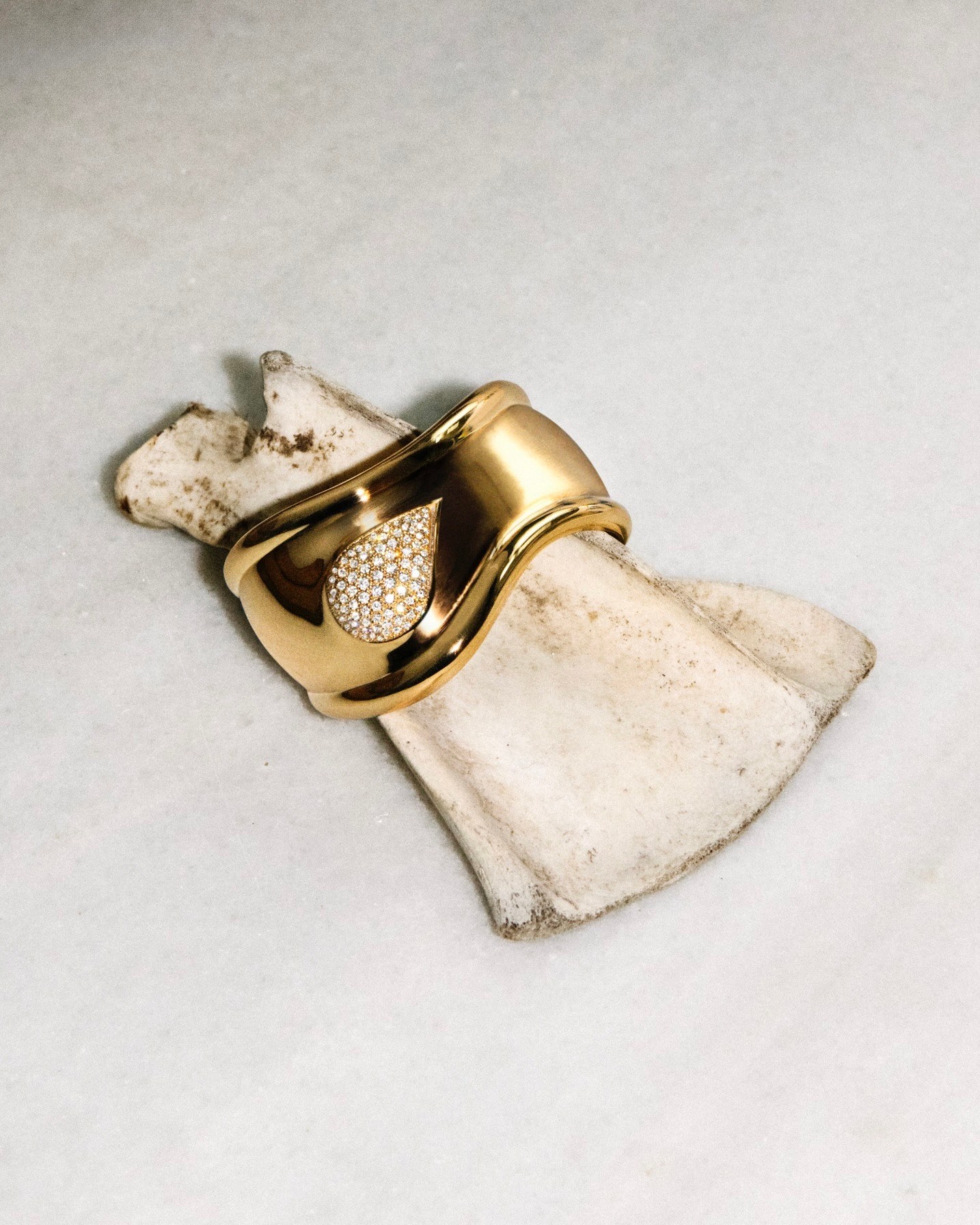 Elsa Peretti Bone cuff in 18k gold with pavé diamonds, small motif, right wrist. (Courtesy of Tiffany & Co.)