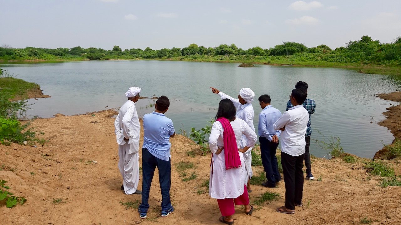Jewelex and VSSM founders surveying one of the completed lakes in Gujarat, India. (Photo courtesy of Jewelex)