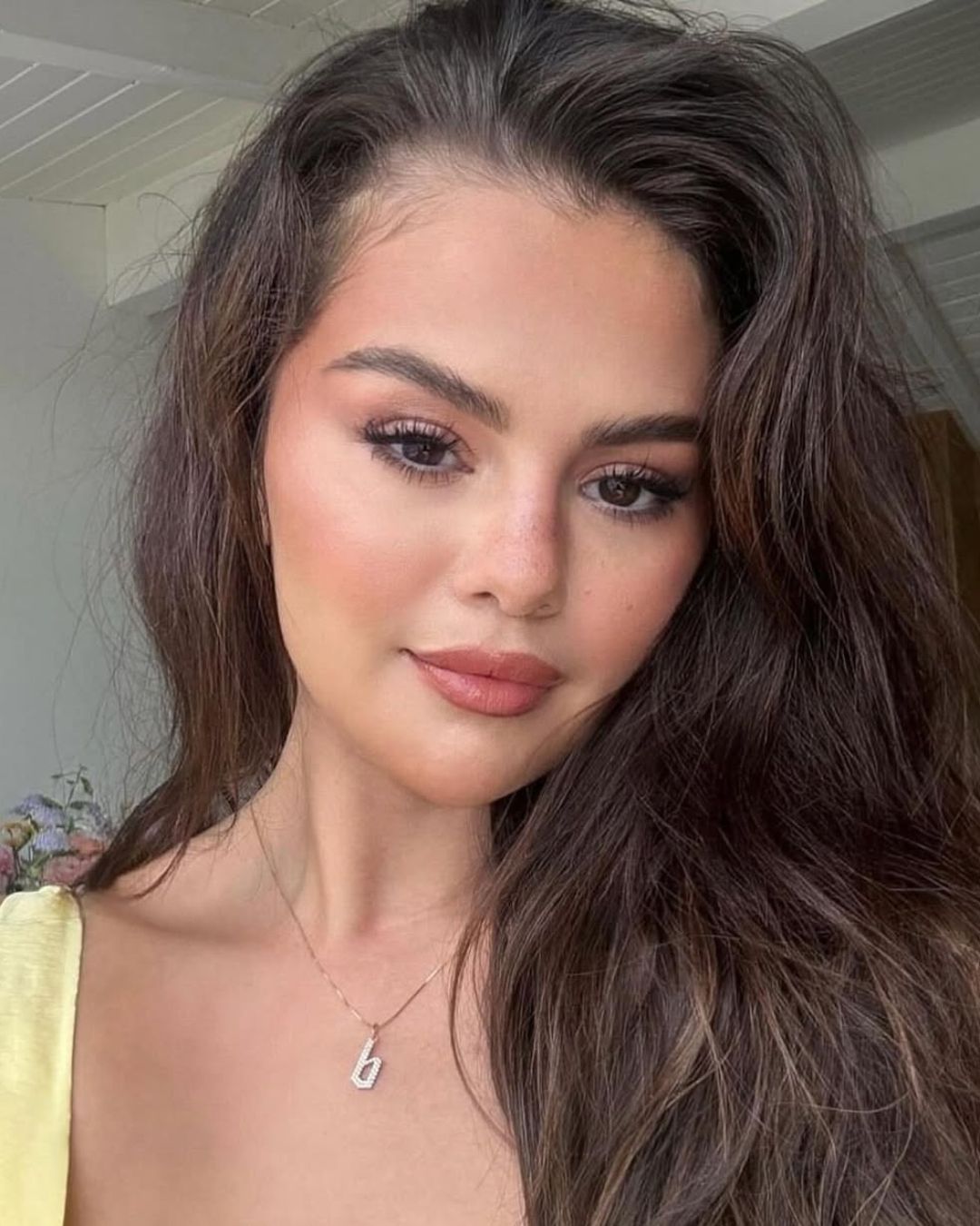 Selena Gomez in a pavé diamond Gothic Old English “b” initial necklace by Baby Gold, styled for her birthday. (instagram.com/selenagomez)
