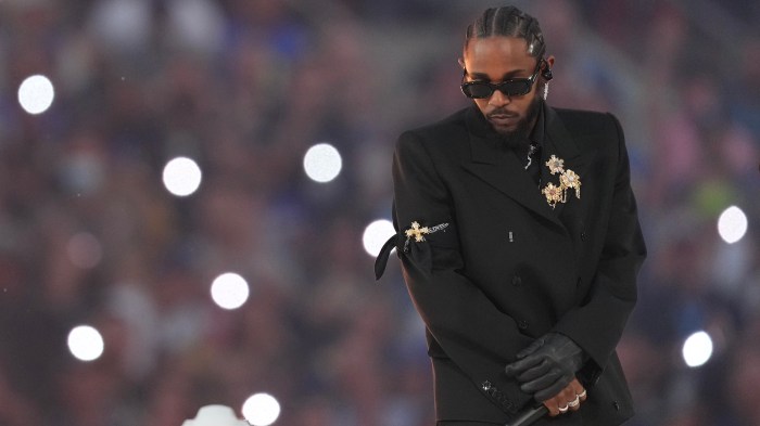 Kendrick Lamar performs in the Halftime Show during the NFL Super Bowl LVI football game, wearing Tiffany & Co. diamond brooches and jewelry.