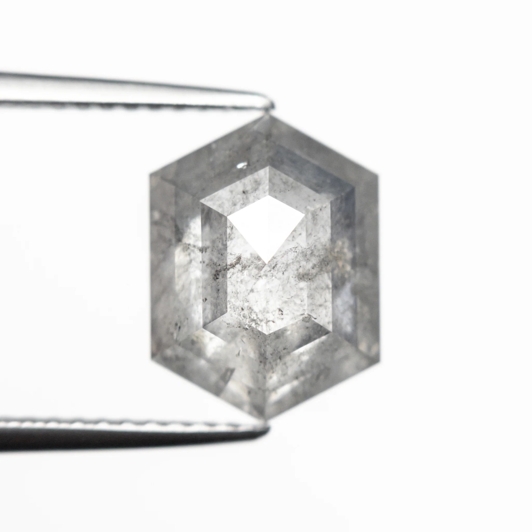 Salt and pepper hexagon step cut diamond are characterized by inclusions