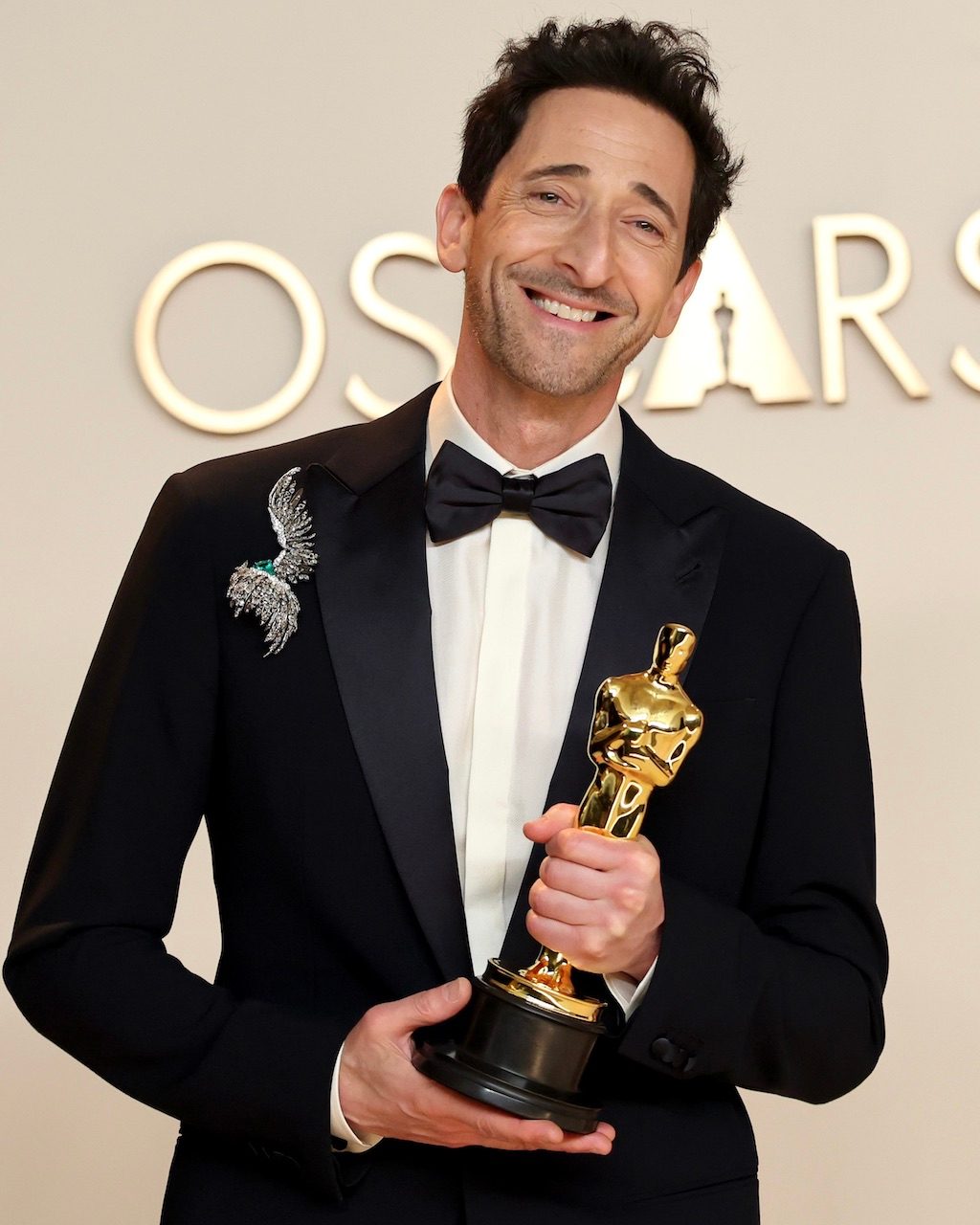 Adrien Brody wears a maximalist diamond brooch at the 2025 Oscars, where he won Best Actor in a Leading Role for “The Brutalist."
