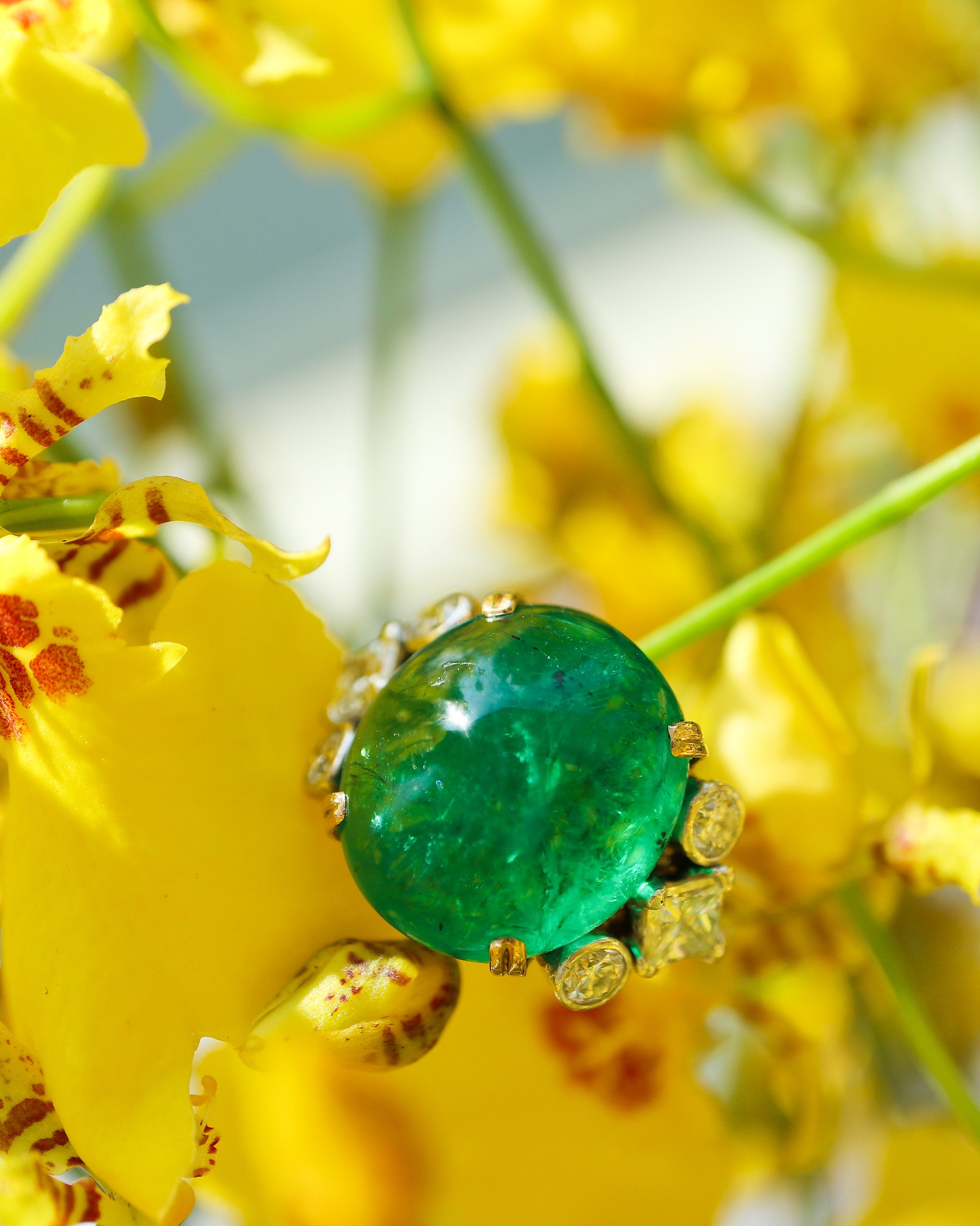 Emerald ring flanked by natural diamonds