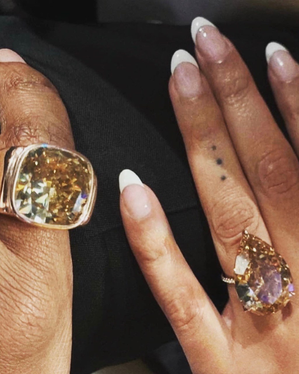 Jay-Z and Beyoncé wear "matching champagne diamonds for the couple who loves champagne." Jay-Z wears a 30-carat champagne diamond pinky ring and Beyoncé wears a 28-carat pear-shape champagne diamond ring, designed by Lorraine Schwartz. champagne diamond ring