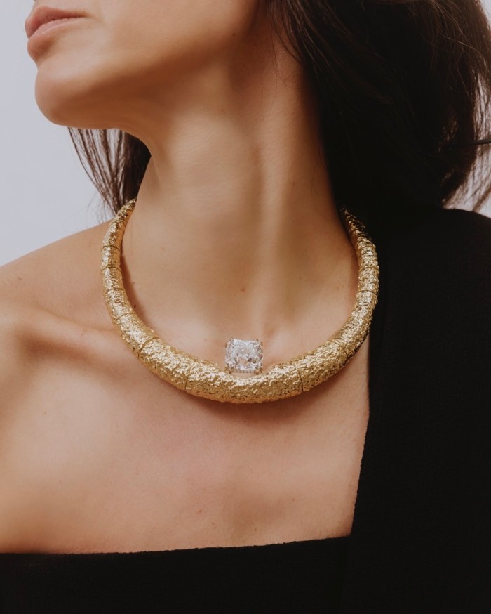 30.05-carat white diamond in a white diamond setting and 18K Fairmined gold raw necklace. The Row dress.