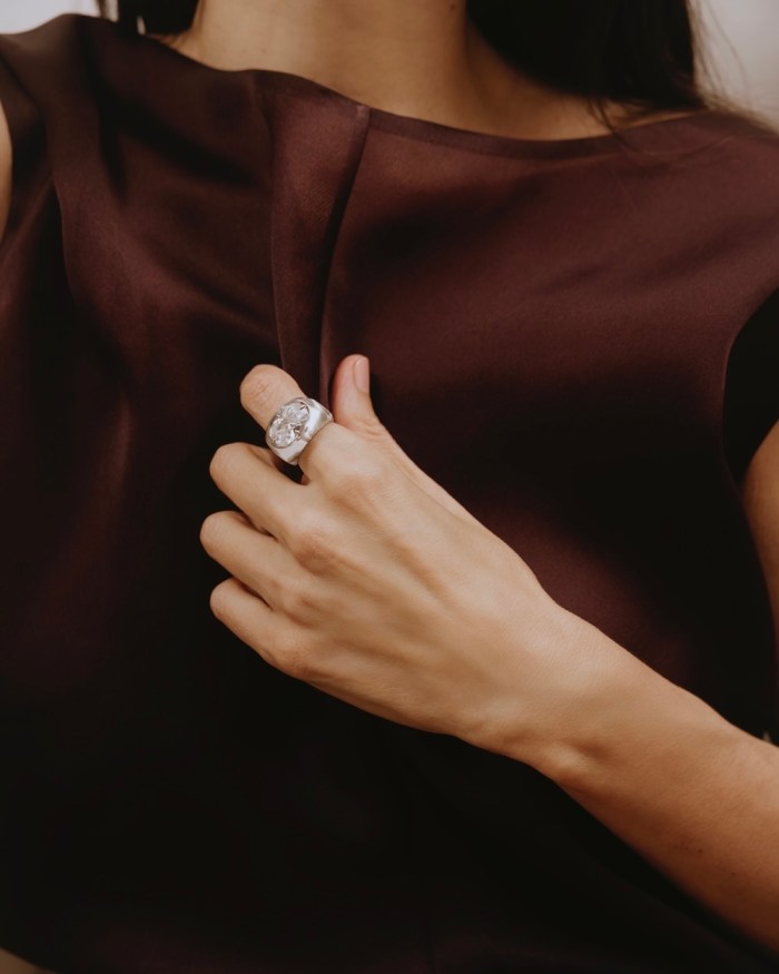 Ana Khouri ring with a 5.18-carat white diamond, rock crystal, and 18K Fairmined gold. Khaite dress.