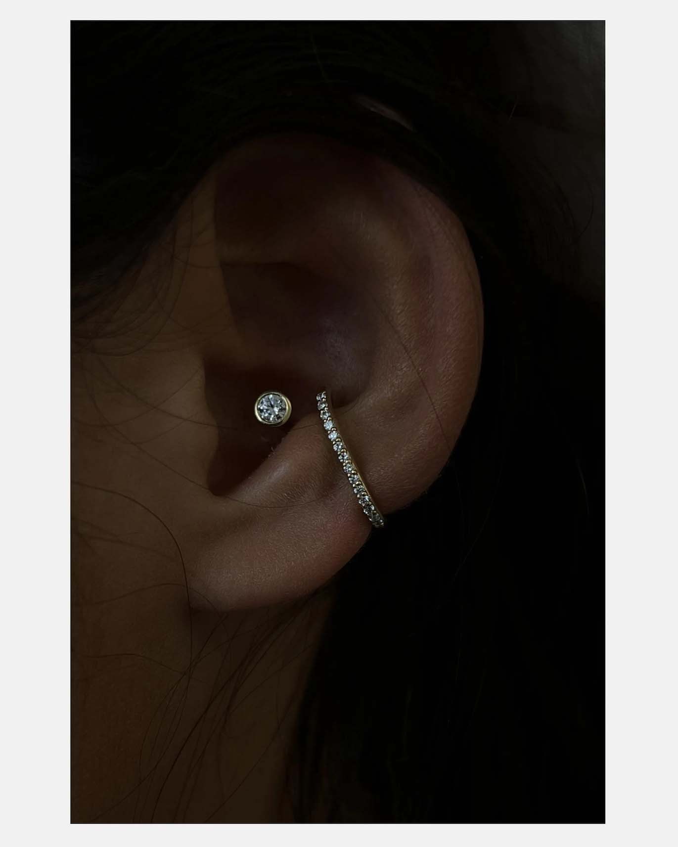 Model wearing ear cuff with pave diamonds
