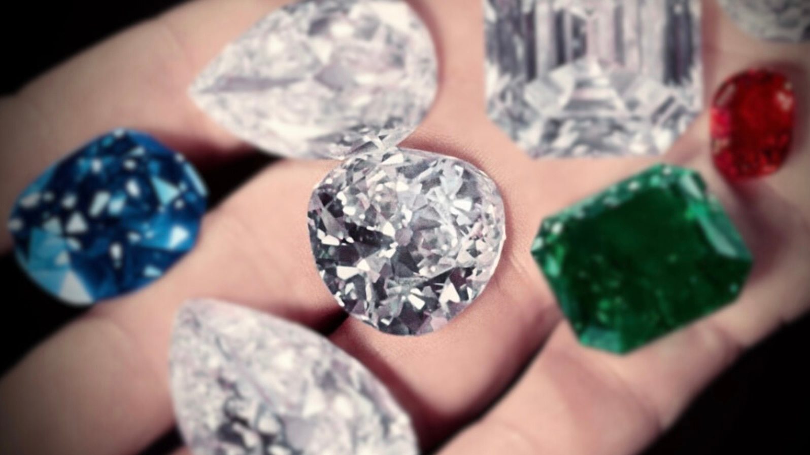 Harry Winston displays some of the gems in his collection in the palm of his hand, including the Sapphire of Catherine the Great (next to thumb), the Hope Diamond (between index & middle), the Royal Spanish Emerald (green), the Idol's Eye diamond (left of emerald), the Jonker Diamond (C, square cut), the Star of the East diamond (tear shaped, bottom), a large ruby and a pair of 50-carat matched pear shaped diamonds. (Photo by Bernard Hoffman/The LIFE Picture Collection/Getty Images)