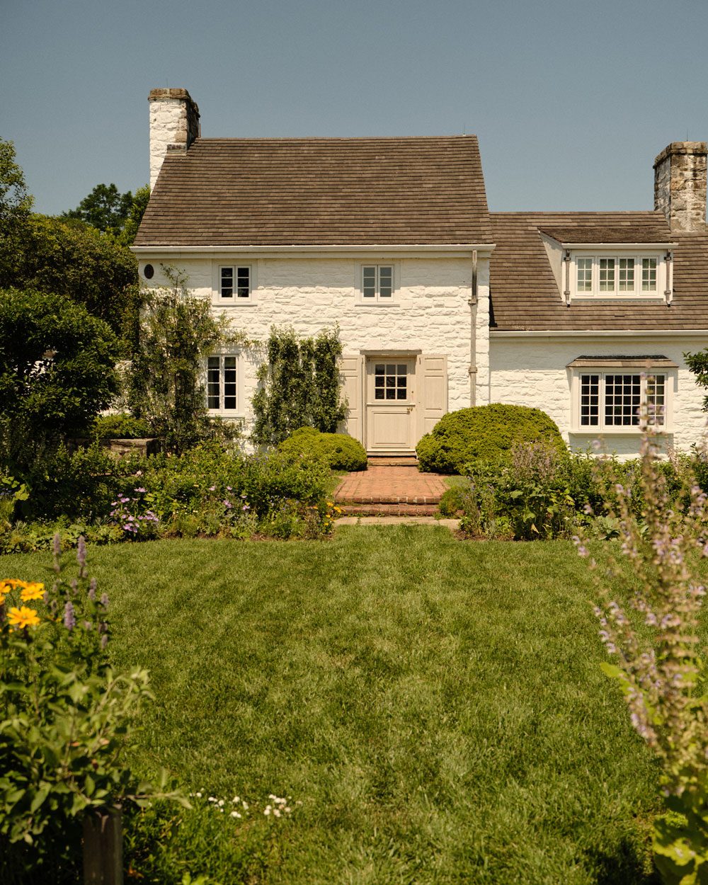The exterior of Bunny Mellon’s beloved Oak Spring estate in Upperville, Virginia, where she spent countless hours gardening and cultivating the serene, understated beauty that defined her life’s aesthetic. (Photographed by Adrian Martin)