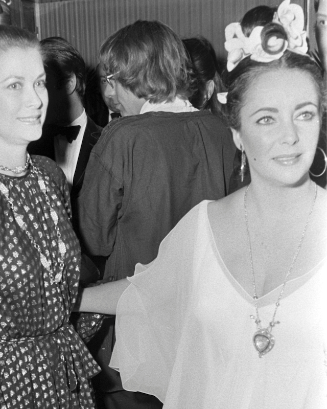 Grace Kelly (L) and Elizabeth Taylor attend a party during Taylor's weekend-long 40th birthday celebration in Budapest, Hungary, on Feb. 26-27, 1972. (Getty Images)