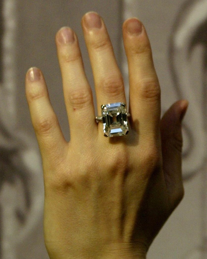 n assistant at Christie's auction house displays a 19.72 carat diamond ring made by Tiffany & Co. owned by heiress Doris Duke, pictured in background, 04 May, 2004. (ALESSANDRO ABBONIZIO/AFP via Getty Images)