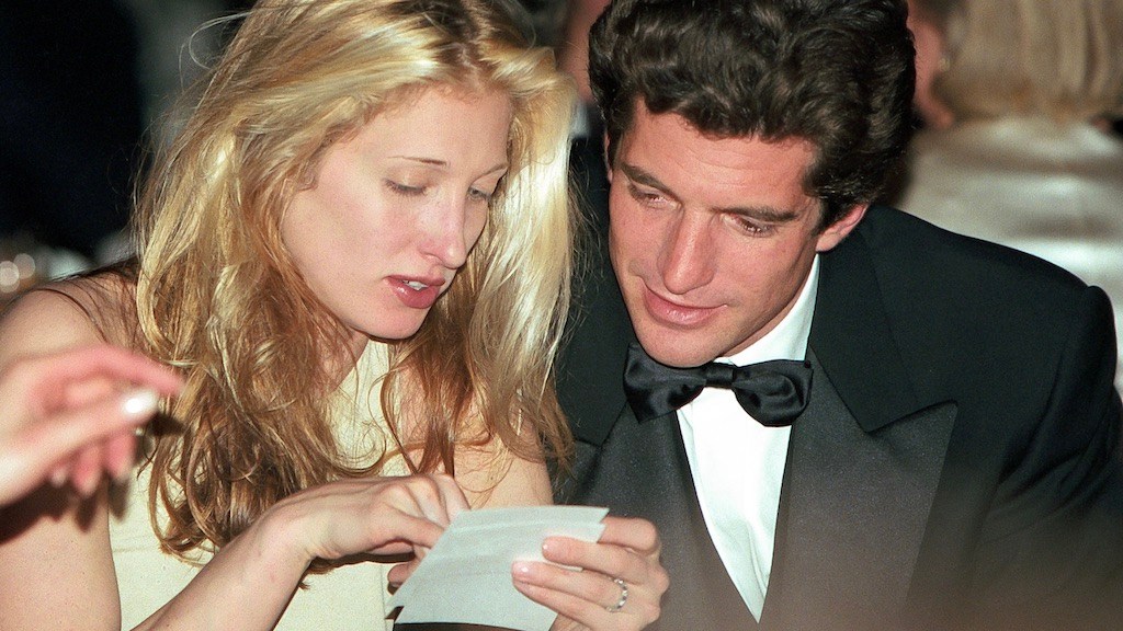 John Kennedy Jr., with his bride-to-be, Carolyn Bessette, wearing her sapphire and diamond eternity band-engagement ring at an event in 1996