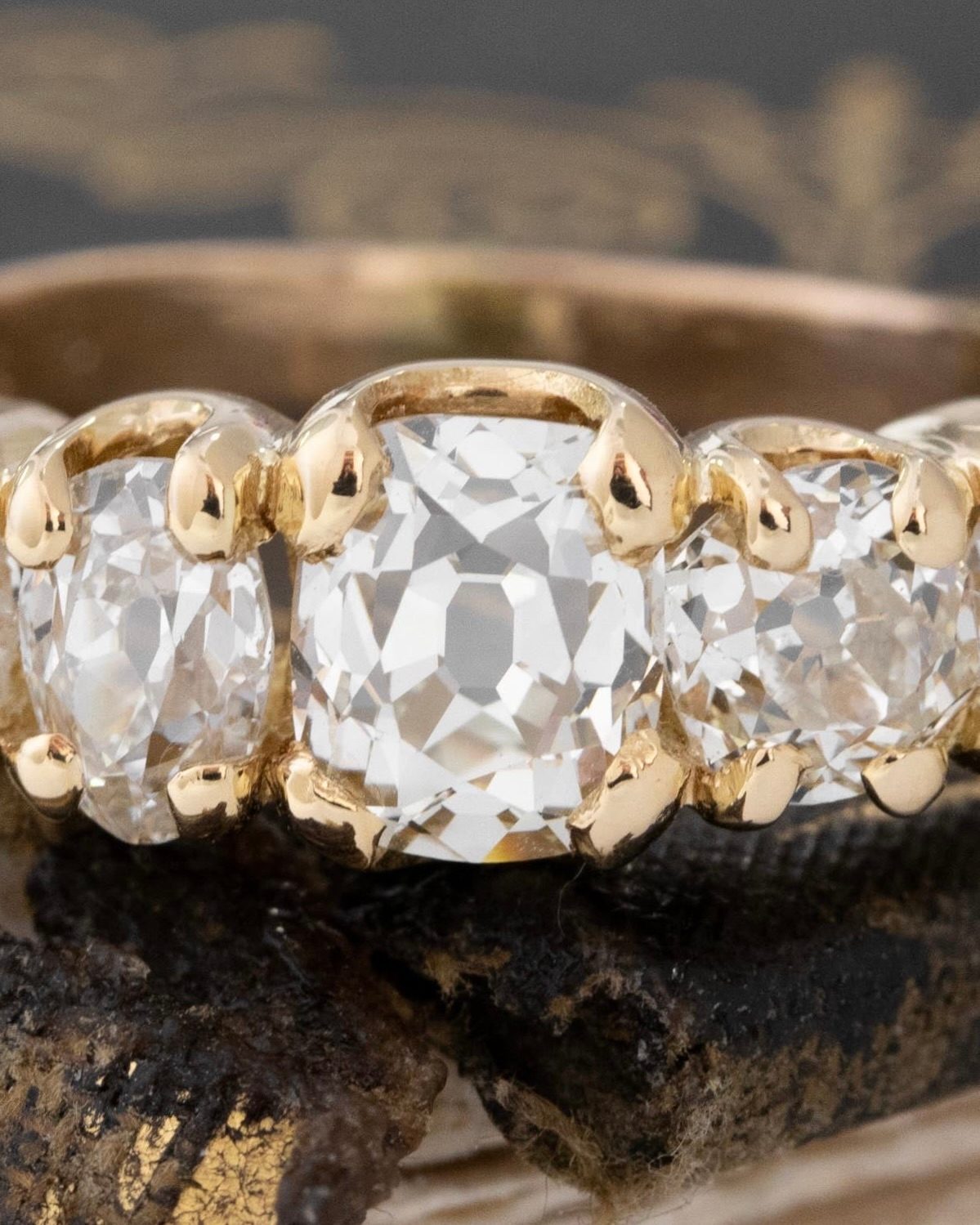 Ring with four old mine cuts with a central peruzzi cut diamond in your classic 5-stone layout