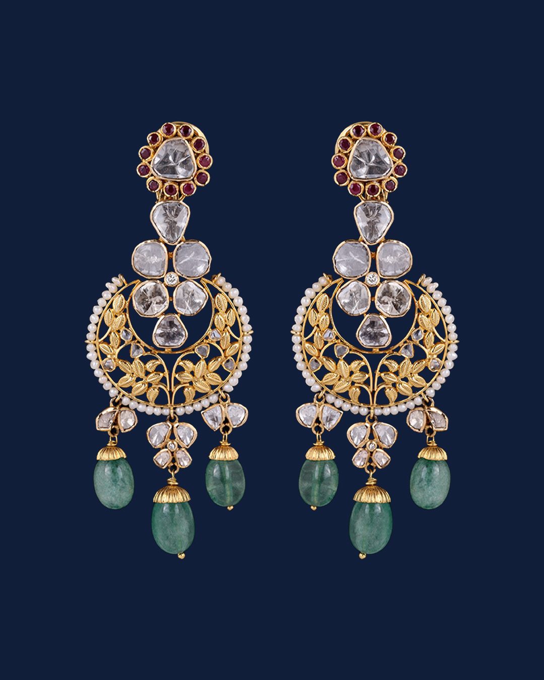 Gold diamond chandbali earrings with floral motifs and green bead drops.