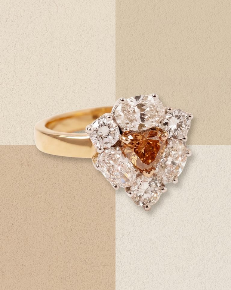 Gold ring with a brown diamond and halo setting.