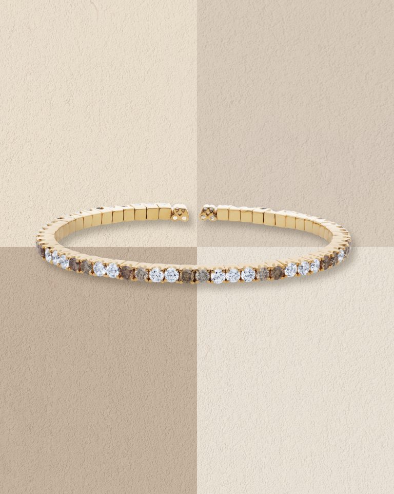 Gold bracelet set with a row of small white diamonds.