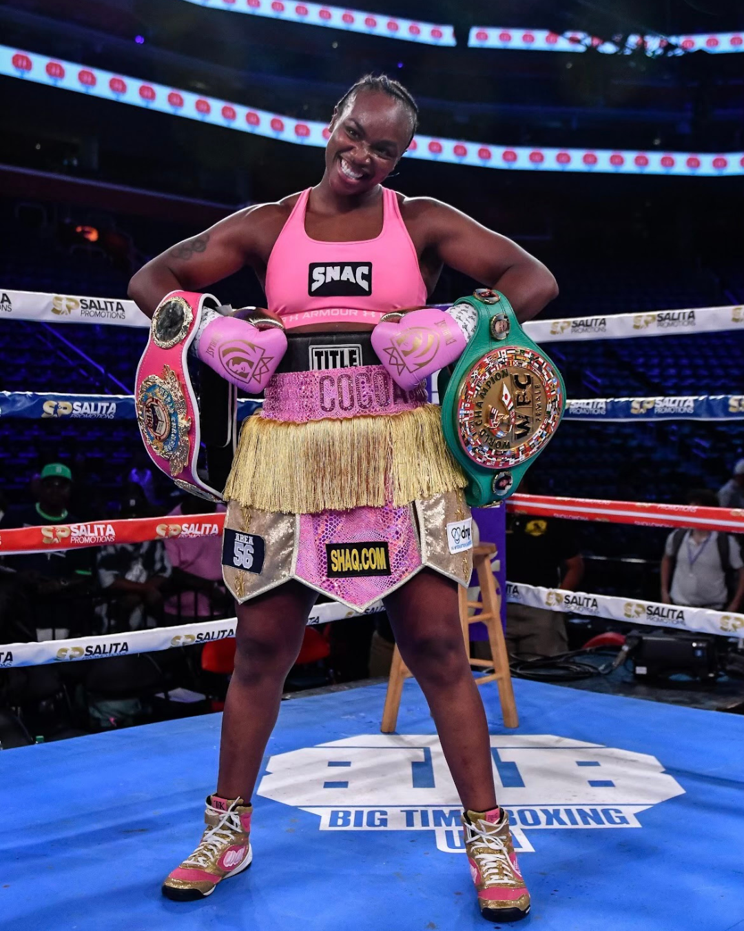 Claressa Shields, the first American boxer to win consecutive Olympic gold medals in 2012 and 2016, shows off her Championship belts. Her 2019 WBO Middleweight Championship Belt (left) is featured in For the Win: Objects of Sports Excellence. (Courtesy of Claressa Shields)
