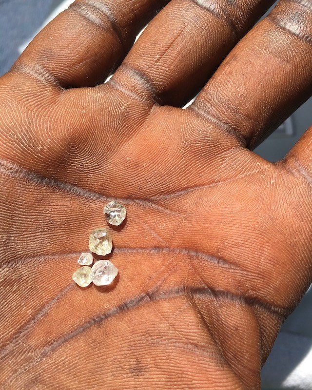 Diamond Traceability Artisanal Miner holding rough diamonds.