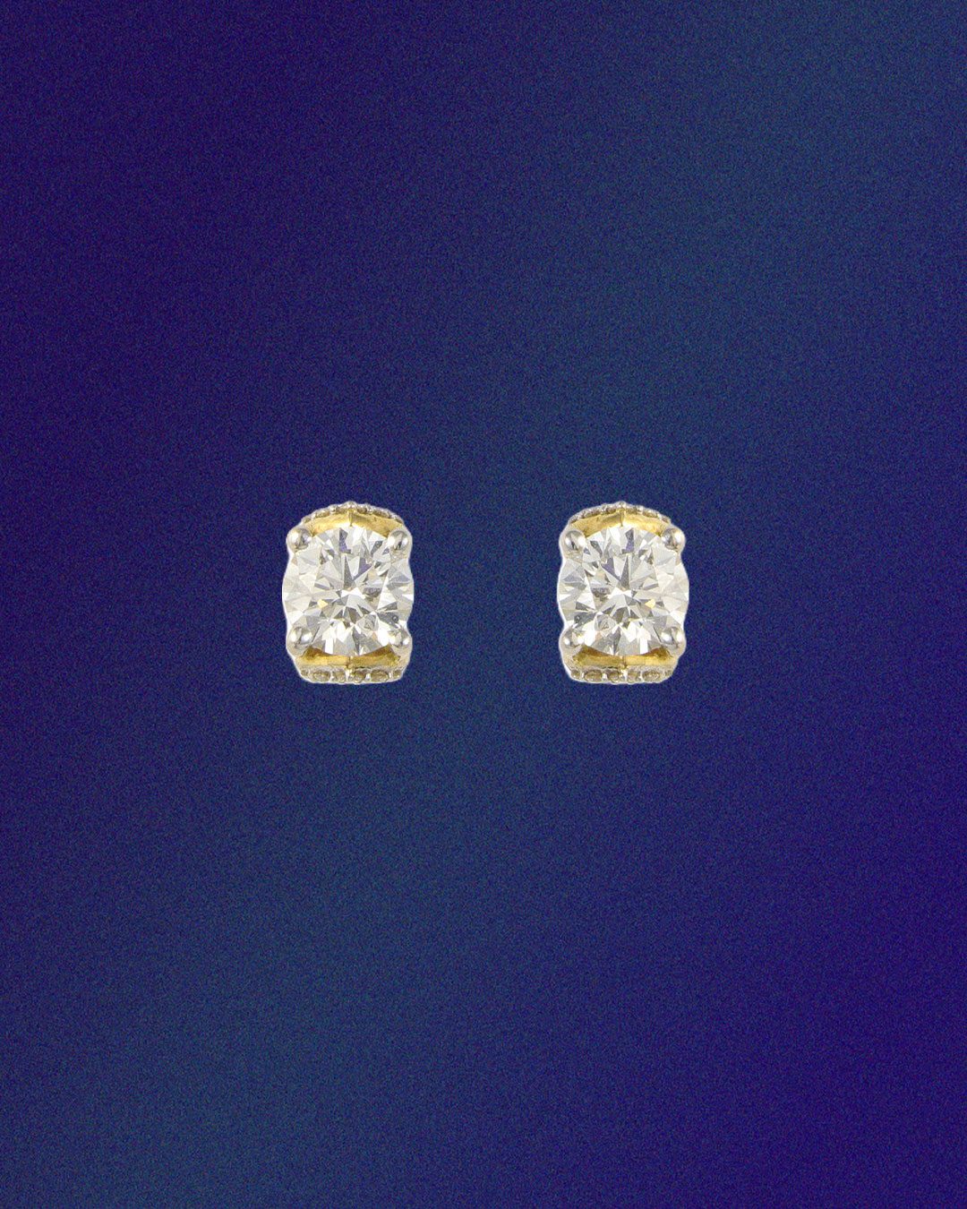Om natural diamond earrings with yellow gold accents.